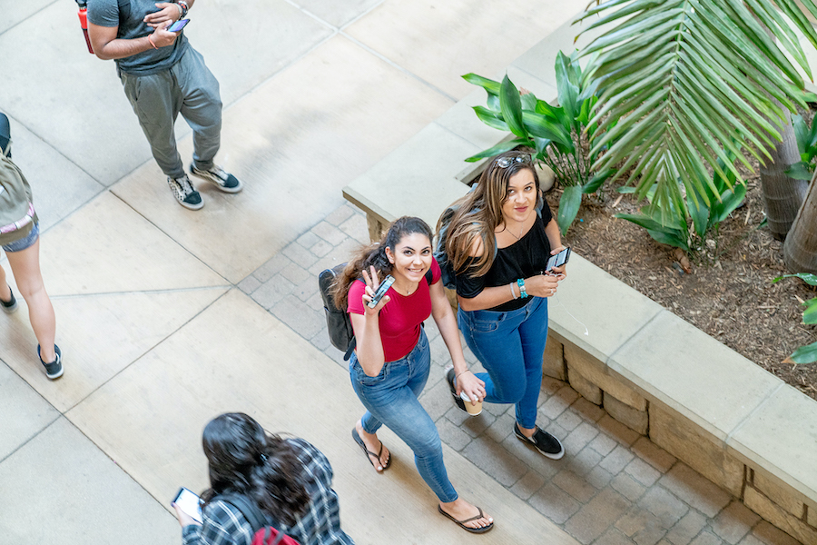 Two students walking in the School of Business