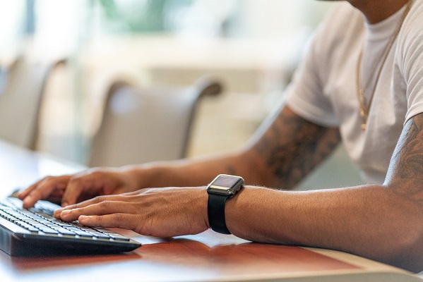 Student typing on keyboard