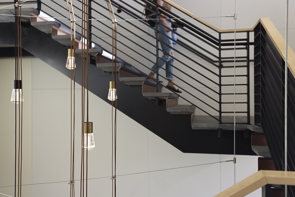 Student walking down the stairs at the College of Engineering