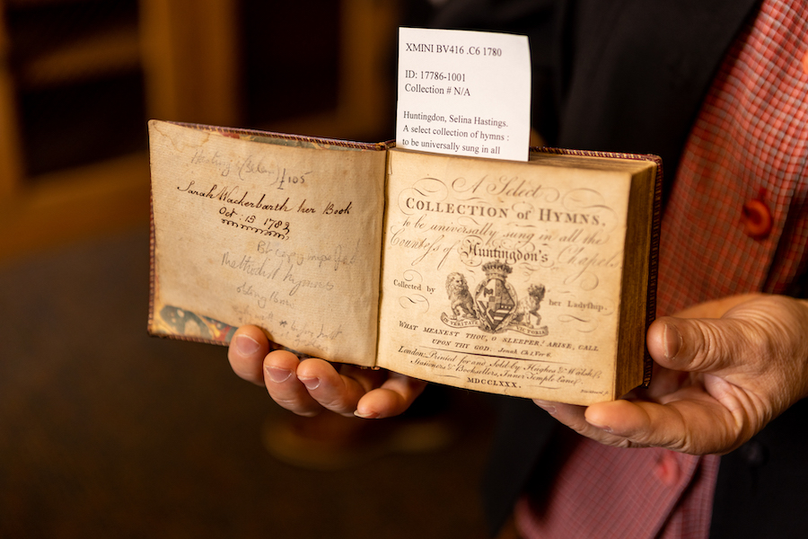 someone holding up an old book