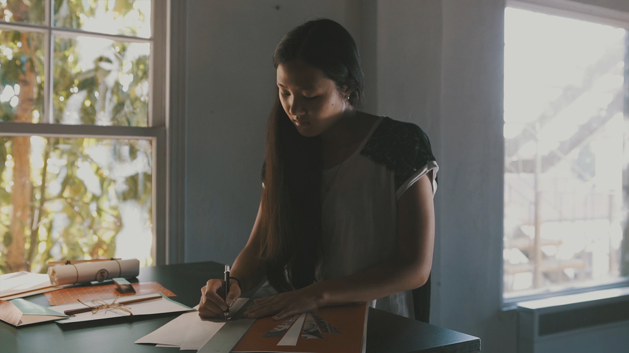 Student drawing with light coming in through windows
