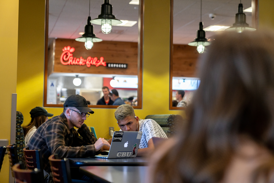 students at Wandas with Chick-fil-A sign in background