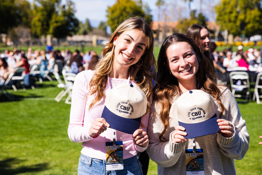 CBU students holding hats