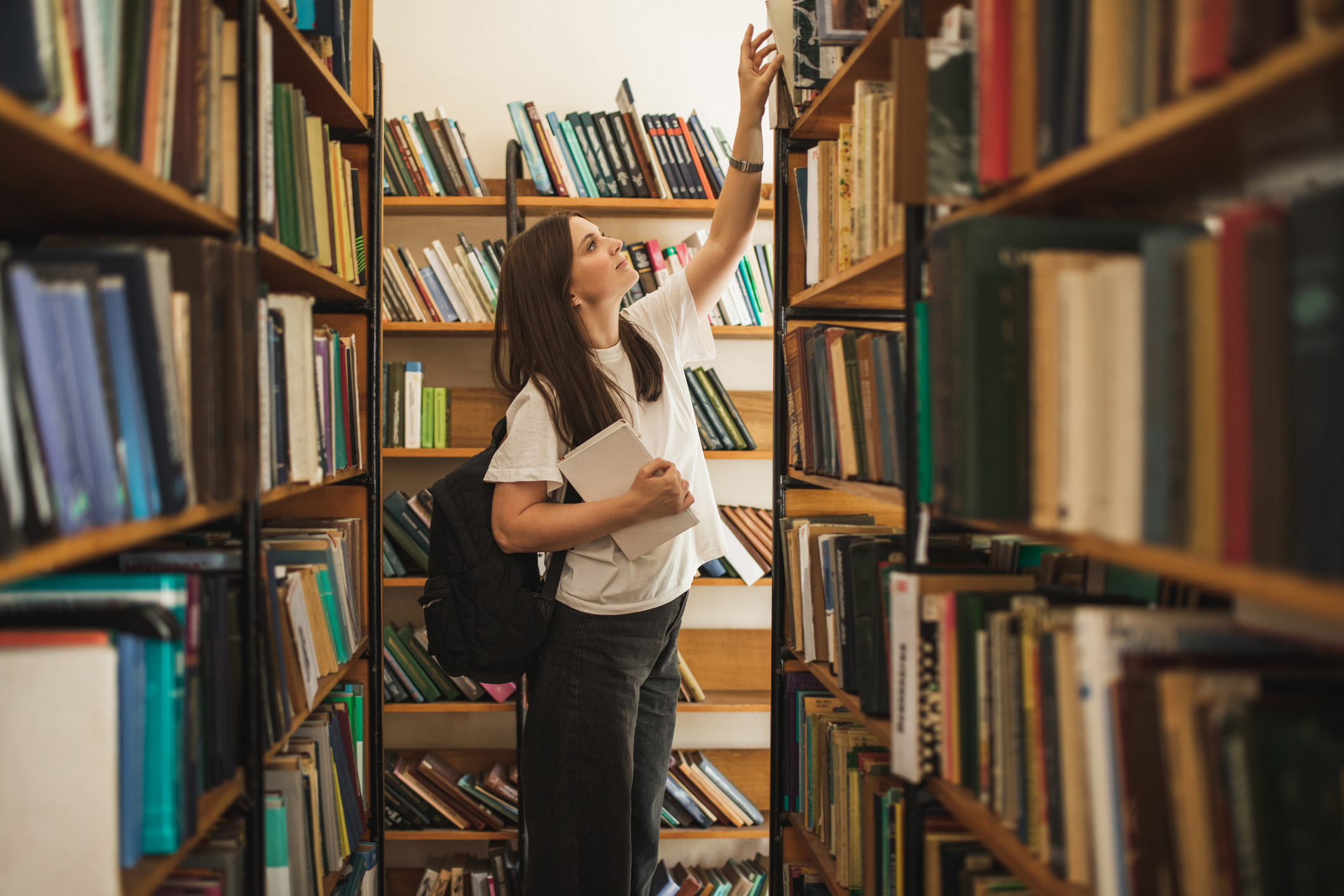 Student looking for a book in the library