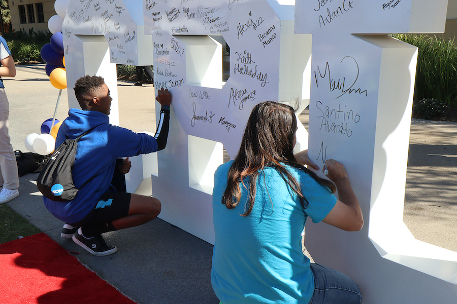 students signing their names on CBU