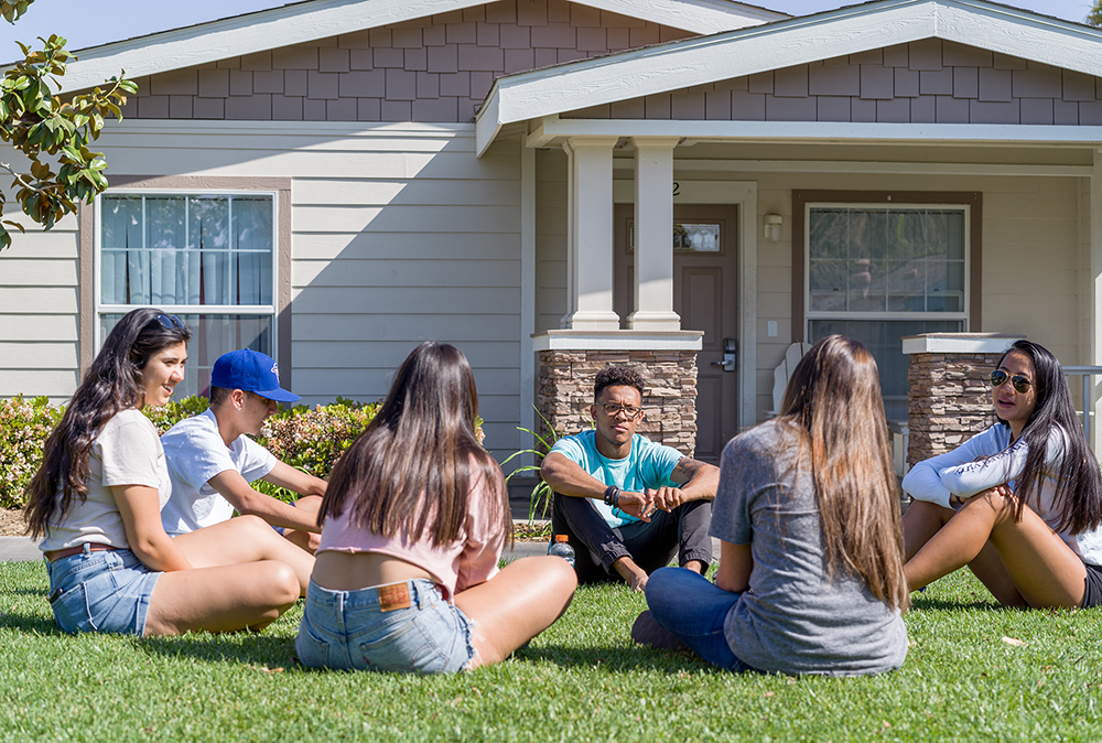 college student sitting on grass
