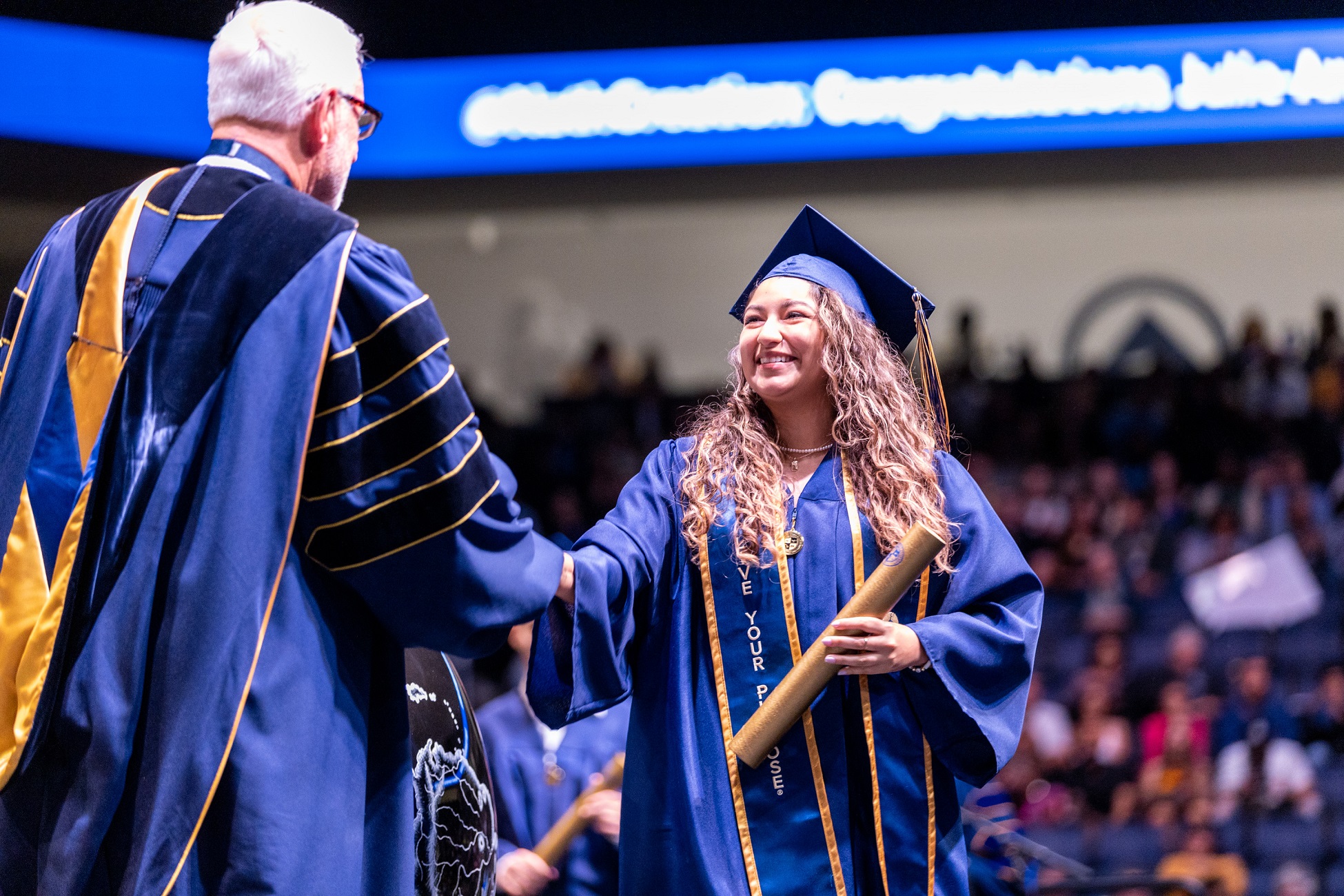 Student awarded diploma at Commencement ceremony