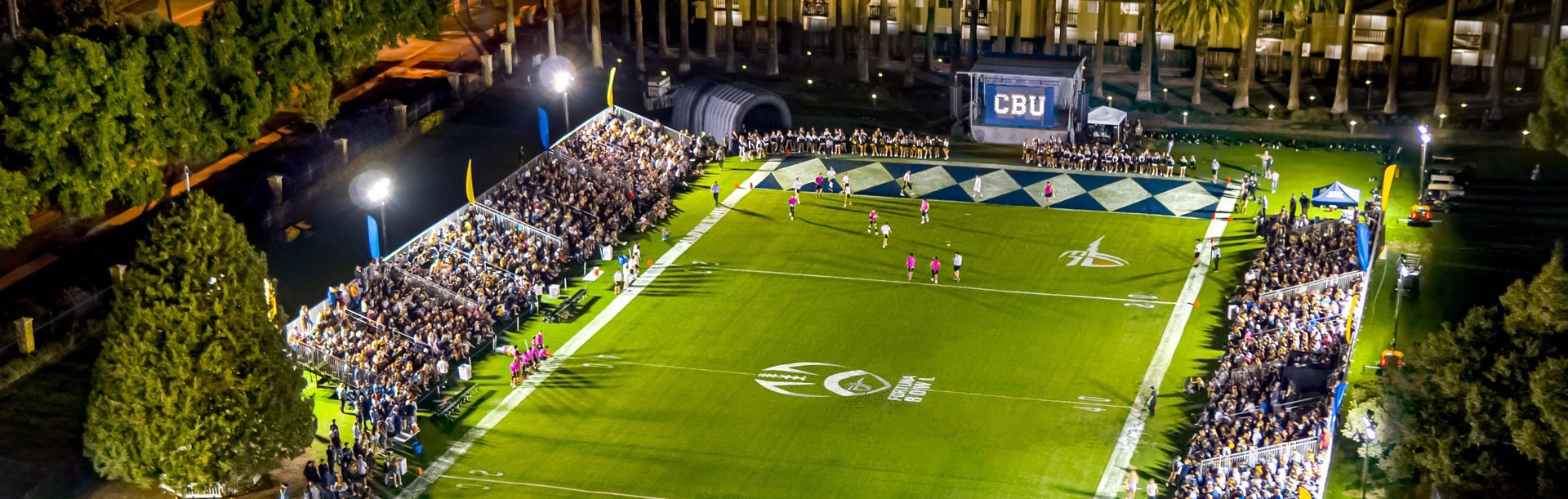 Crowd cheering on teams at the Fortuna Bowl on a CBU field