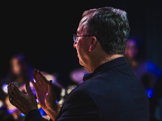 Conductor clapping along to music