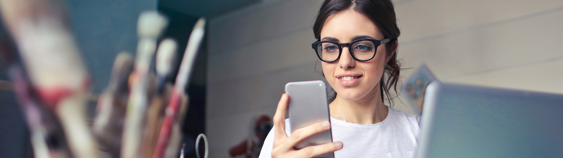 Woman on phone and laptop