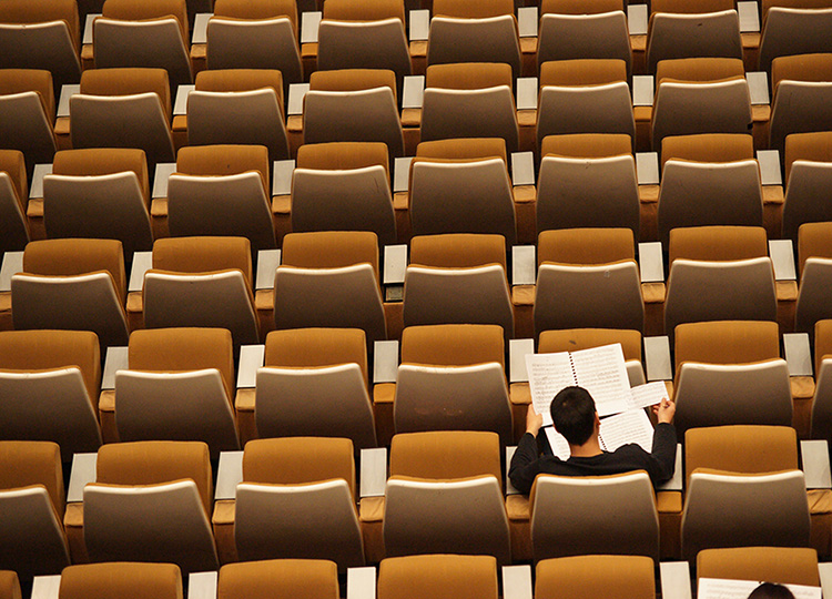 Student sitting in chair studying