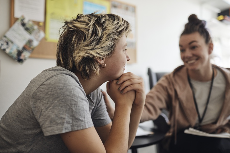 2 women conversating in a small room