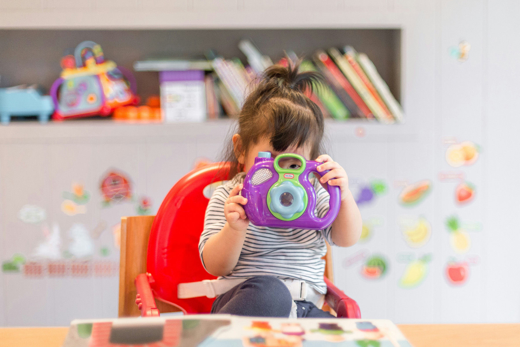 young girl with camera in classroom
