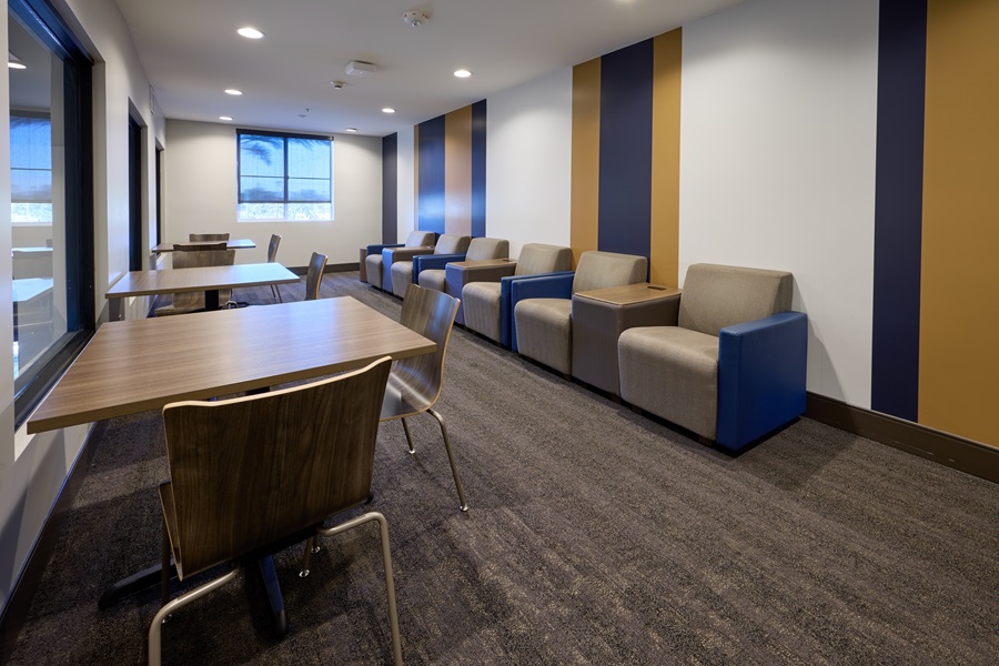 Study area with coaches and tables set up. blue and gold painted walls