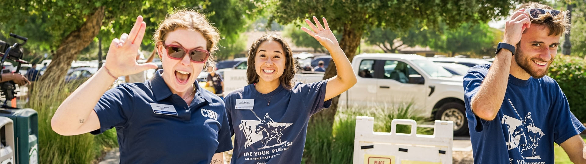 3 students doing the "lance up" hand sign