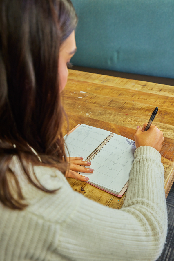 student writing in planner