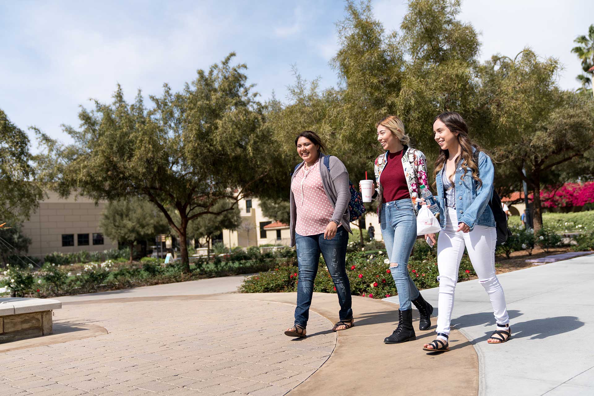 Students walking on campus with their lunch
