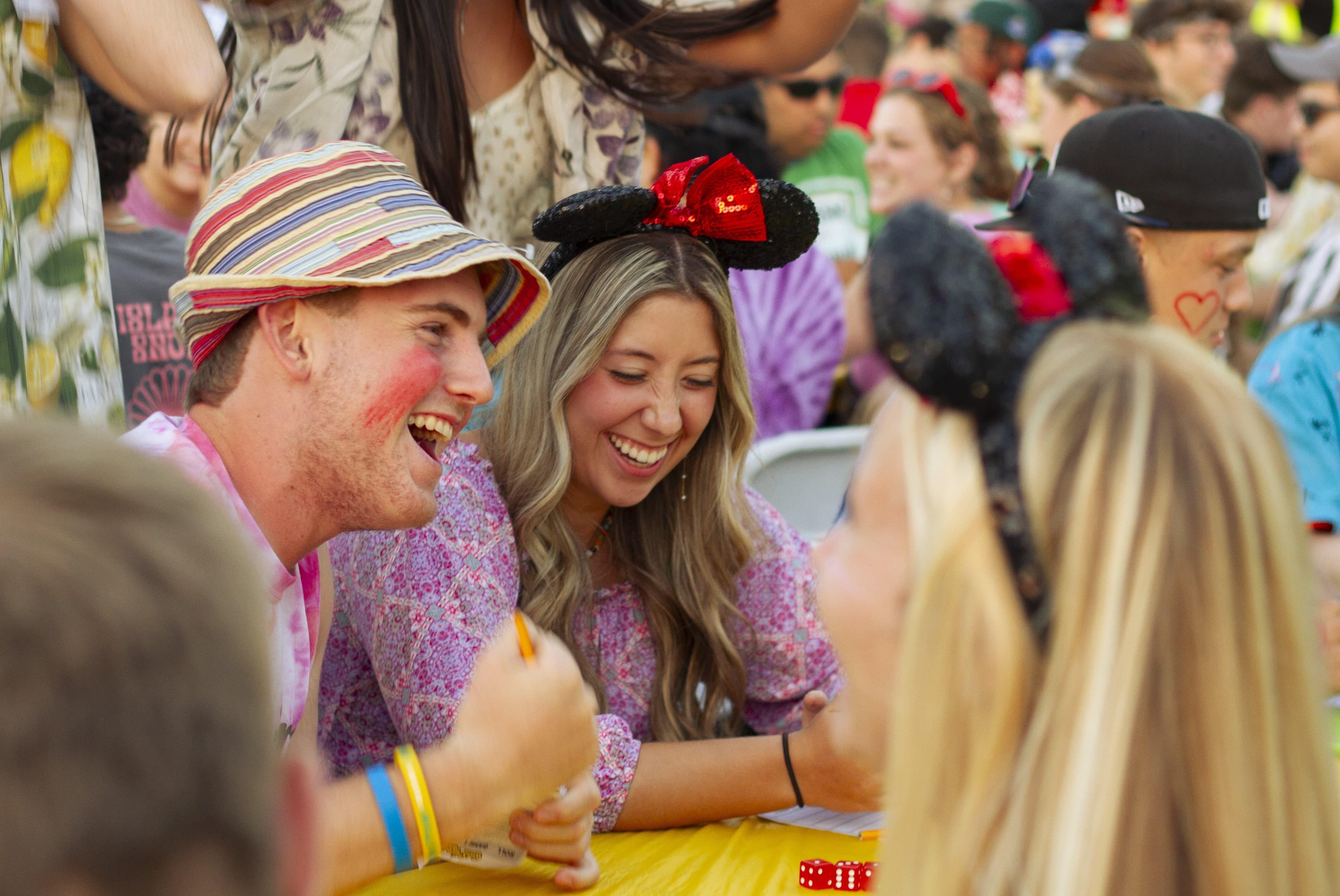 Friends laughing and playing games at a lively outdoor event
