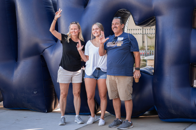 Family lancing up in front of balloons 