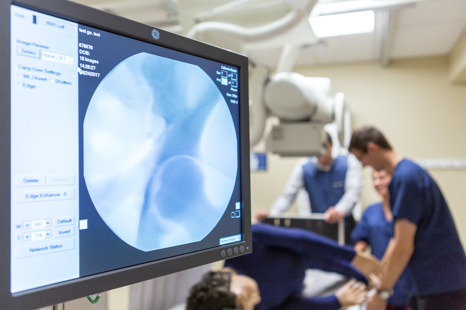 CBU students practicing with an x-ray machine on a medical model